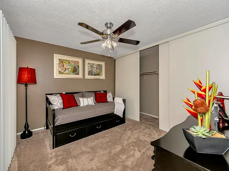 Large bedroom with wall to wall closet and ceiling fan