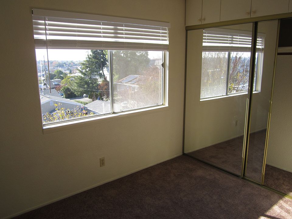 Similar to bedroom with mirrored sliding door and spacious upper cabinets