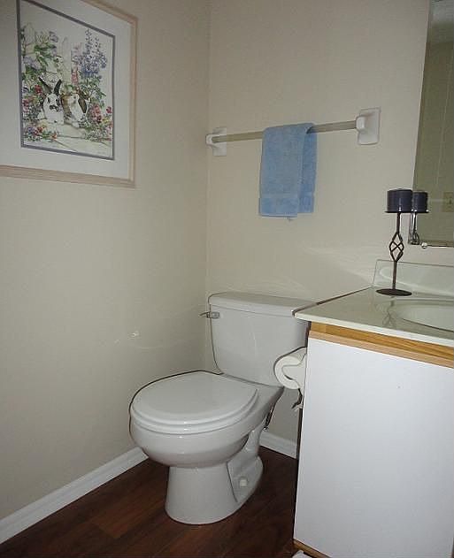 Half bath off foyer with new cherry amber floors.