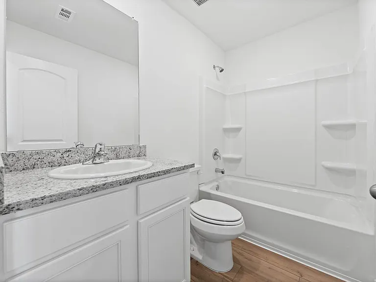 The second bathroom with granite countertops.
