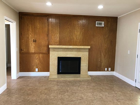Marble fireplace in dining room, French doors to covered patio to the left