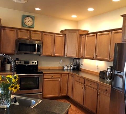 Kitchen has lots of beautiful cupboards and an island w more storage.