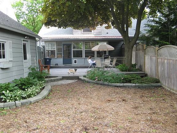 Huge trex deck with overhanging maple tree.