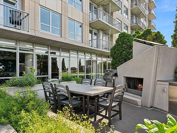 Awesome outdoor kitchen with fireplace, grill, sink and dining!