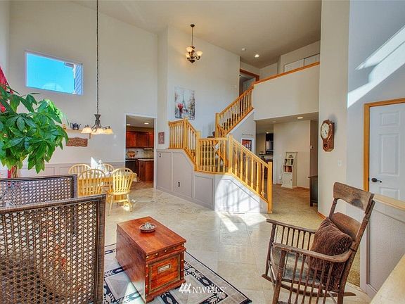 Light and Bright Living, Dining and Stairway from Entry with two story vaulted ceiling 