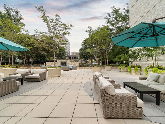 Outdoor terrace with lounge seating, firepit and gas grills