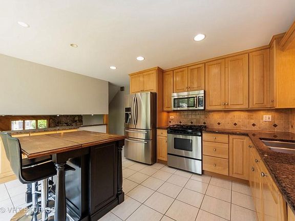 Kitchen with modern appliances and plenty of light. Island is moveable, not attached to floor. Granite counters, except on island.