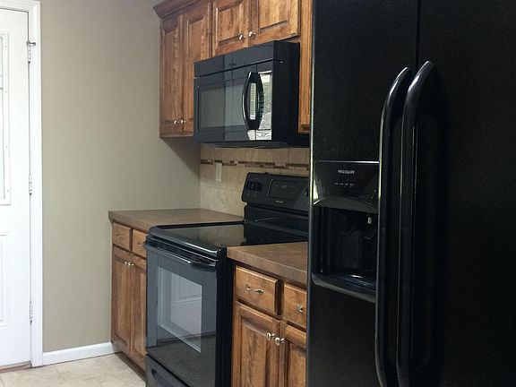 Side-by-side fridge with ice maker and water dispenser on the door, stove/oven & microwave.