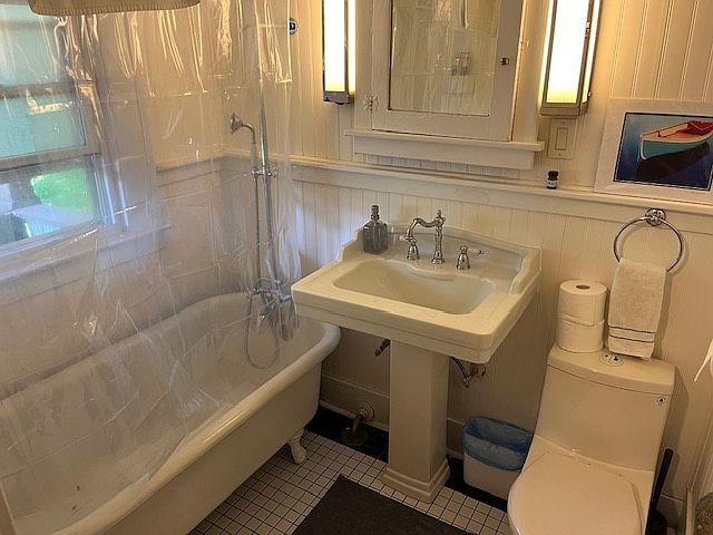 Bathroom with clawfoot tub and updated plumbing hardware