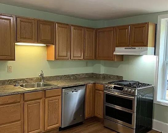 Kitchen with dishwasher and gas stove.