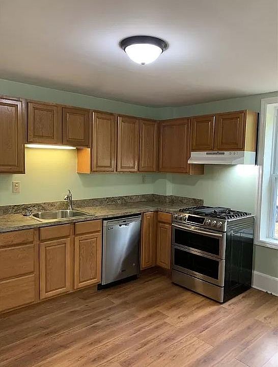 Kitchen with dishwasher and gas stove.