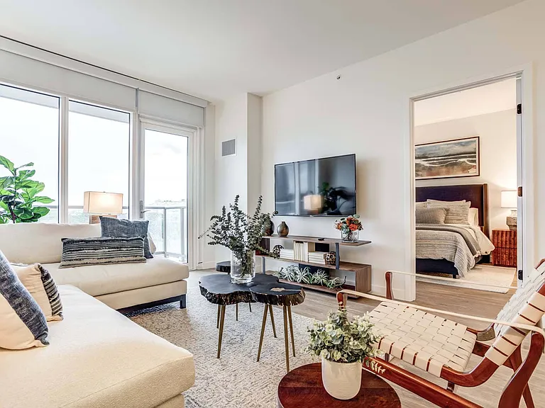 Unwind in a stylish living room, designed for comfort and flow, with large windows that enhance the open, airy feel of the space.
