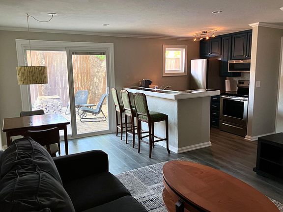 Spacious main living area with view to a private back patio.