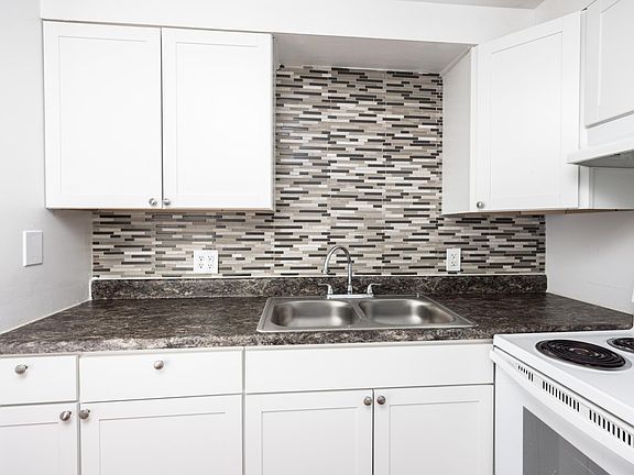 Newly tiled back splash and double sink in kitchen!