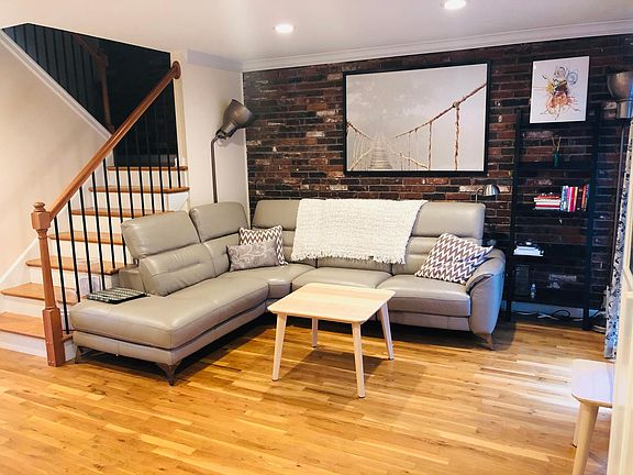 Living room. The floor to ceiling window on the right adds lots of natural light. Blinds and curtain also give you as much privacy as you wish. Happy to sell you this gently-used high-end leather couch that reclines, if you're interested.