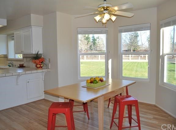 Breakfast nook overlooking large lawn and mature landscaping.