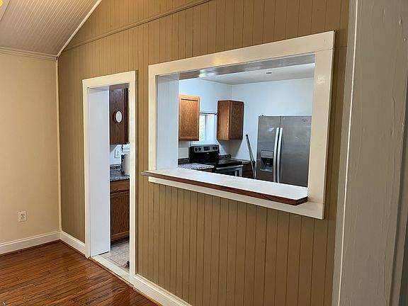 Bar top eating area off of dining area looking into the kitchen.