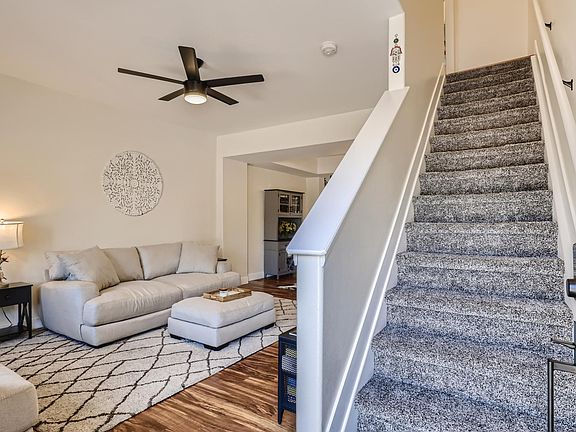 from front door, you are welcomed with open living space and the stairs leading to bedrooms