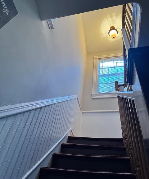 Well lit stairs with a turn to the right and 4 more steps to the second floor.