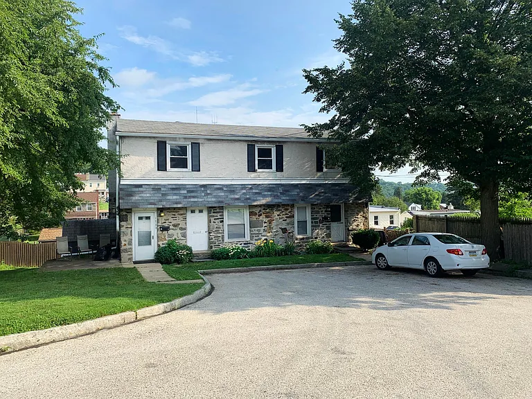Exterior: private entrance, private patio, grassy yard, two parking spaces in driveway