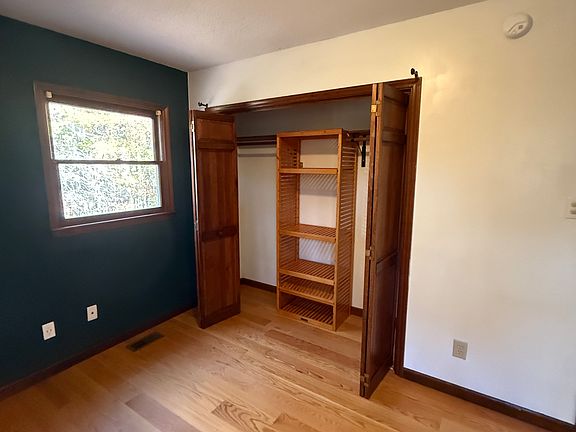 Upstairs back bedroom features custom shelving in closet