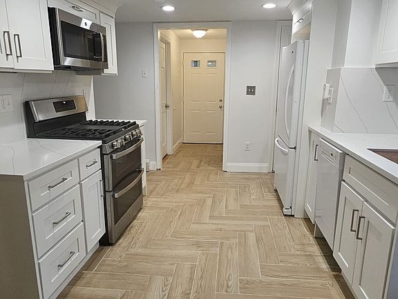 New porcelain tiled kitchen flooring in a herringbone pattern