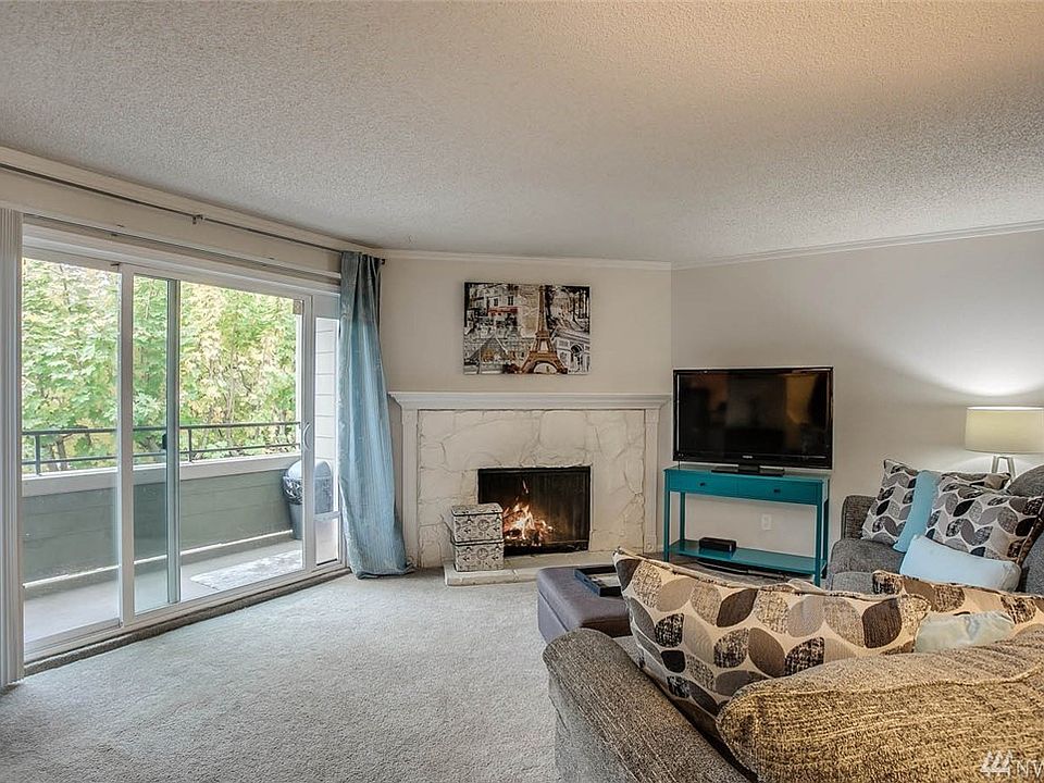 Western exposure living room with wood burning fireplace.  Carpet and interior paint were installed in 2016. 
