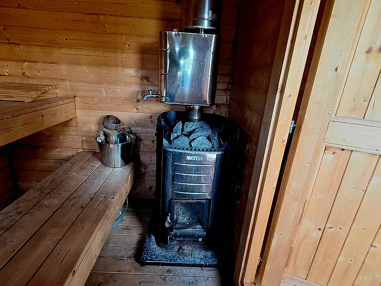 A private outdoor sauna offers a spa-like experience rarely found in furnished rentals.