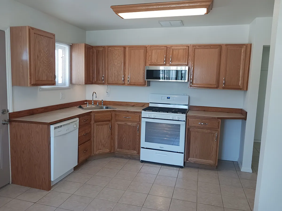 Oak kitchen with newer stove, refrigerator & microwave hood - Mesquite Springs Rd