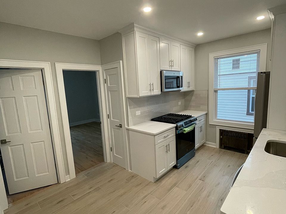 kitchen leading to bedroom 1 on the right and 2nd bedroom on the left