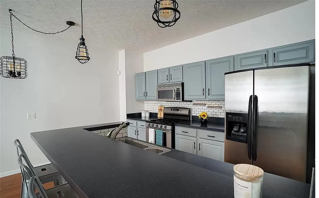 Kitchen with modern appliances, including microwave and dishwasher! - 1222 E Chapman Ln #2