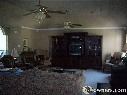 Den with Cathedral Ceiling and two Ceiling Fans