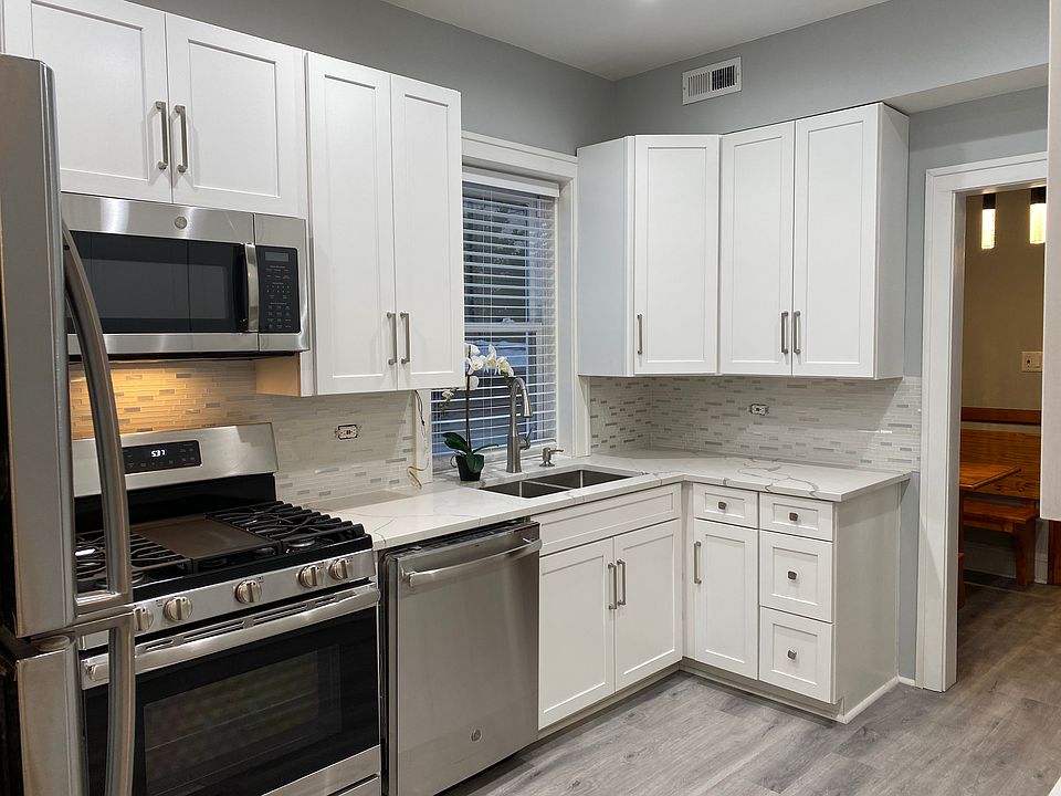 New kitchen with stainless steel appliances and quartz counter tops