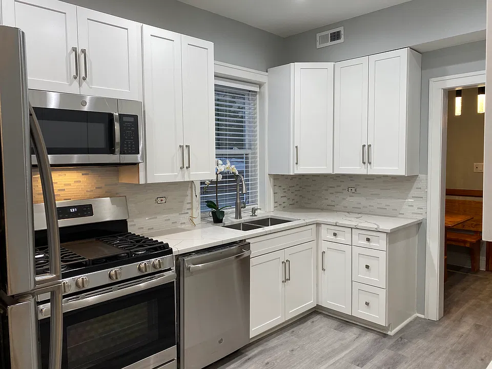New kitchen with stainless steel appliances and quartz counter tops
