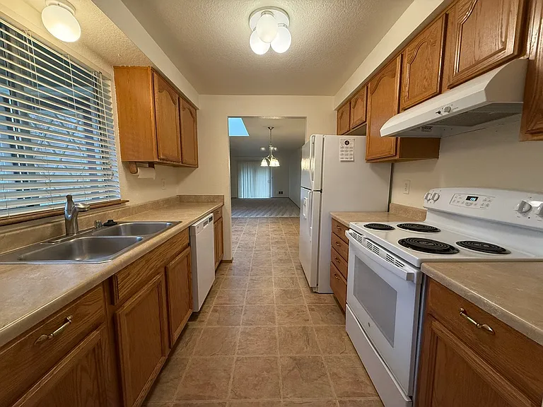 Full view of kitchen, dining room beyond.