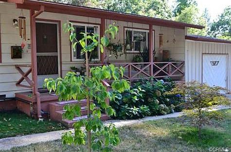 The lovely covered front porch makes a wonderful place to sit an