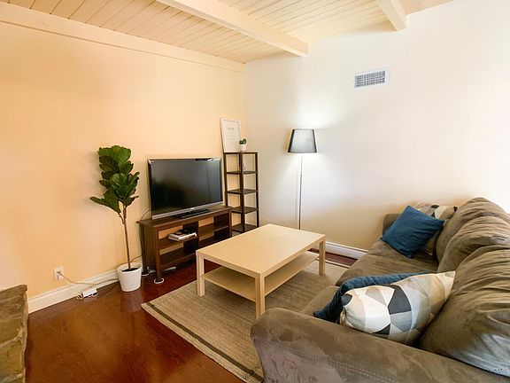 Living room with TV equipped with Amazon Firestick.