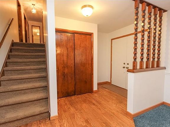 Nice sized entry way and beautiful hardwood floors. Stairs lead to three upper bedrooms, master bath