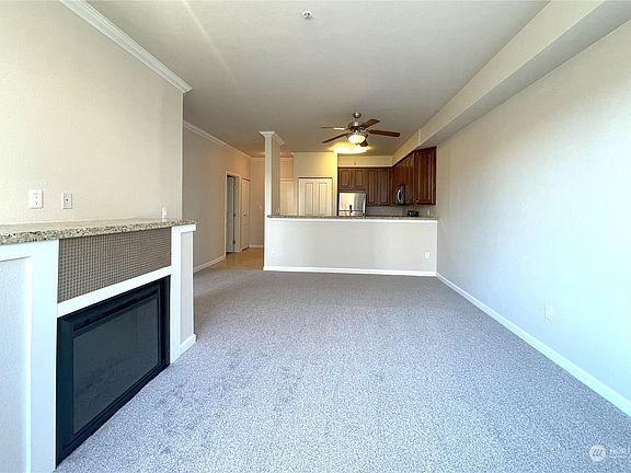 Light, Bright & Luxurious Living  Soaring ceilings and expansive windows fill this stunning living space with natural light, creating an airy and inviting atmosphere. Fresh interior paint and brand-new flooring enhance the modern elegance, making this the perfect place to relax or entertain in style.>