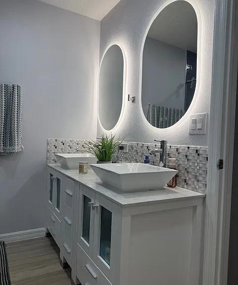 Stylish upgraded bathroom with double vanity and modern finishes for a spa-like feel. Primary bedroom bathroom