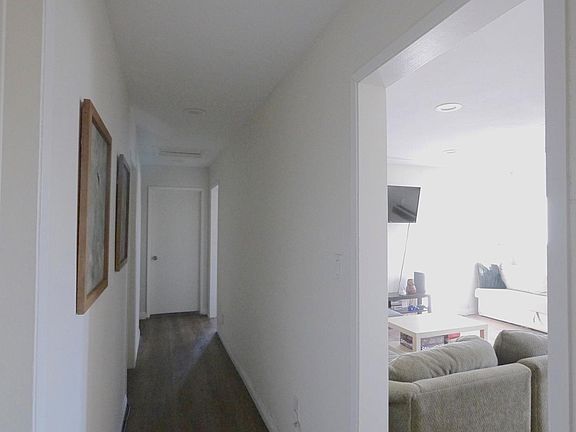 Hallway that leads to bedrooms. The one on the far right is 