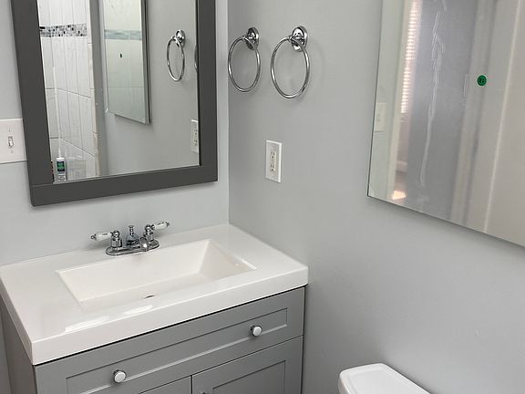 bathroom with new vanity, sink, fixtures, hardware, and mirror/medicine cabinet