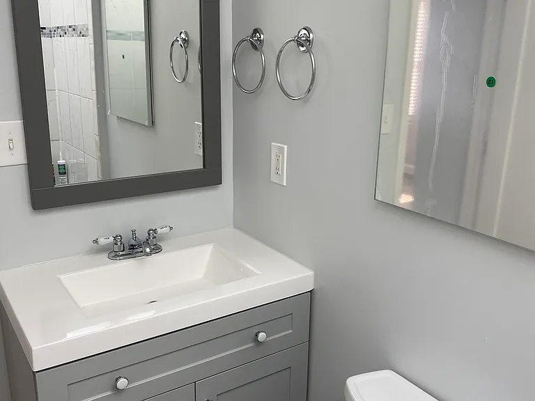 bathroom with new vanity, sink, fixtures, hardware, and mirror/medicine cabinet
