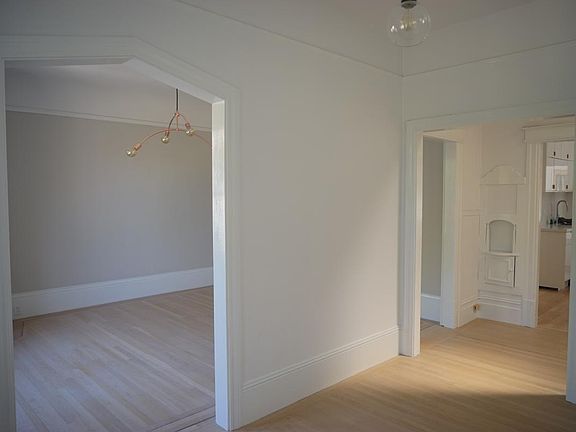 View from dining room into living room and kitchen