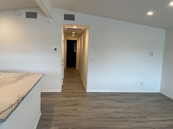 Entering front door, front room, kitchen to left, hall to bedrooms and bathrooms.