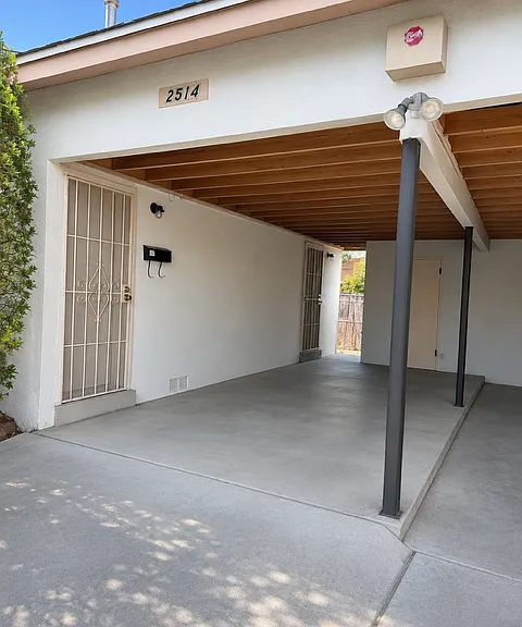 Entrance with carport and storage