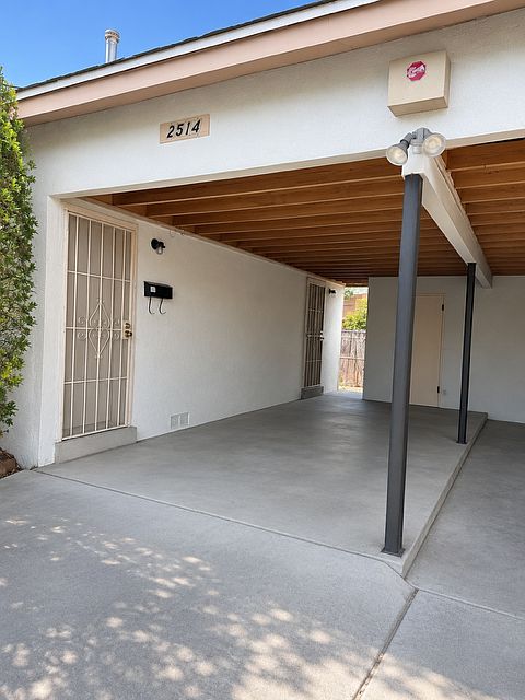 Entrance with carport and storage
