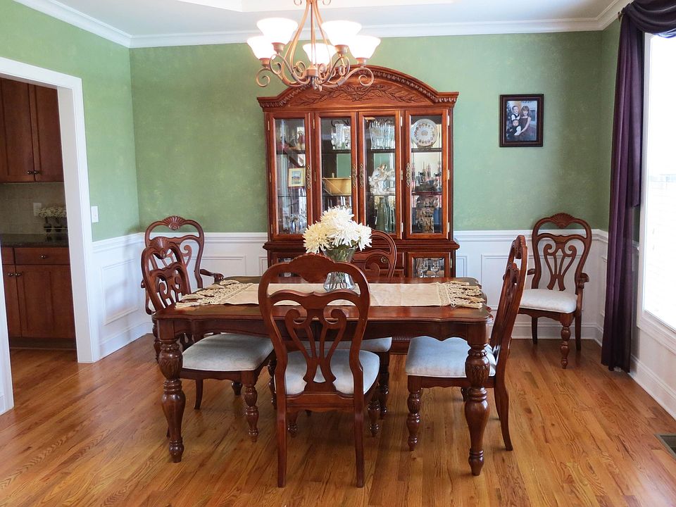 The dining room has hardwood floors and opens off the foyer. 