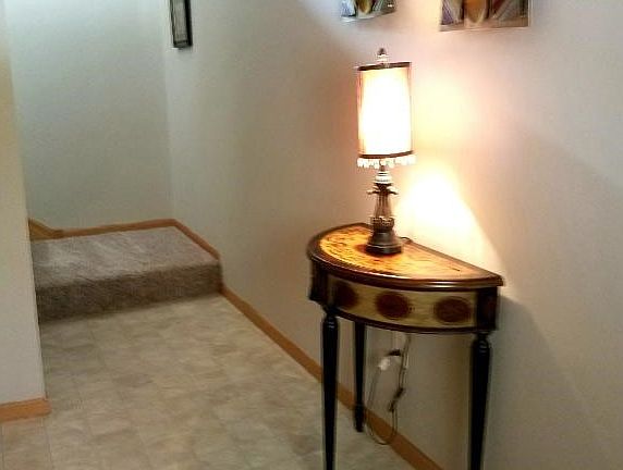 Enter into an open foyer offering plenty of room for a decorative table or chair.
