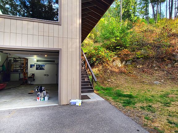 Large one bay garage and living above. Wonderful flat grassy area to the right